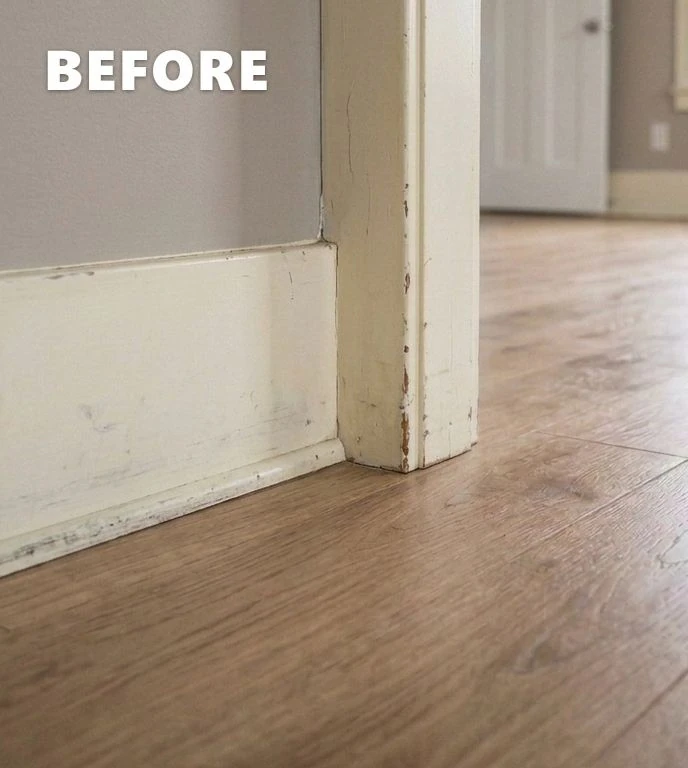 Before: Yellowed baseboard trim with scratches